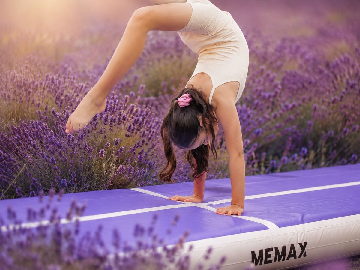 Child performing a handstand on a inflatable airtrack with lavender field in the background