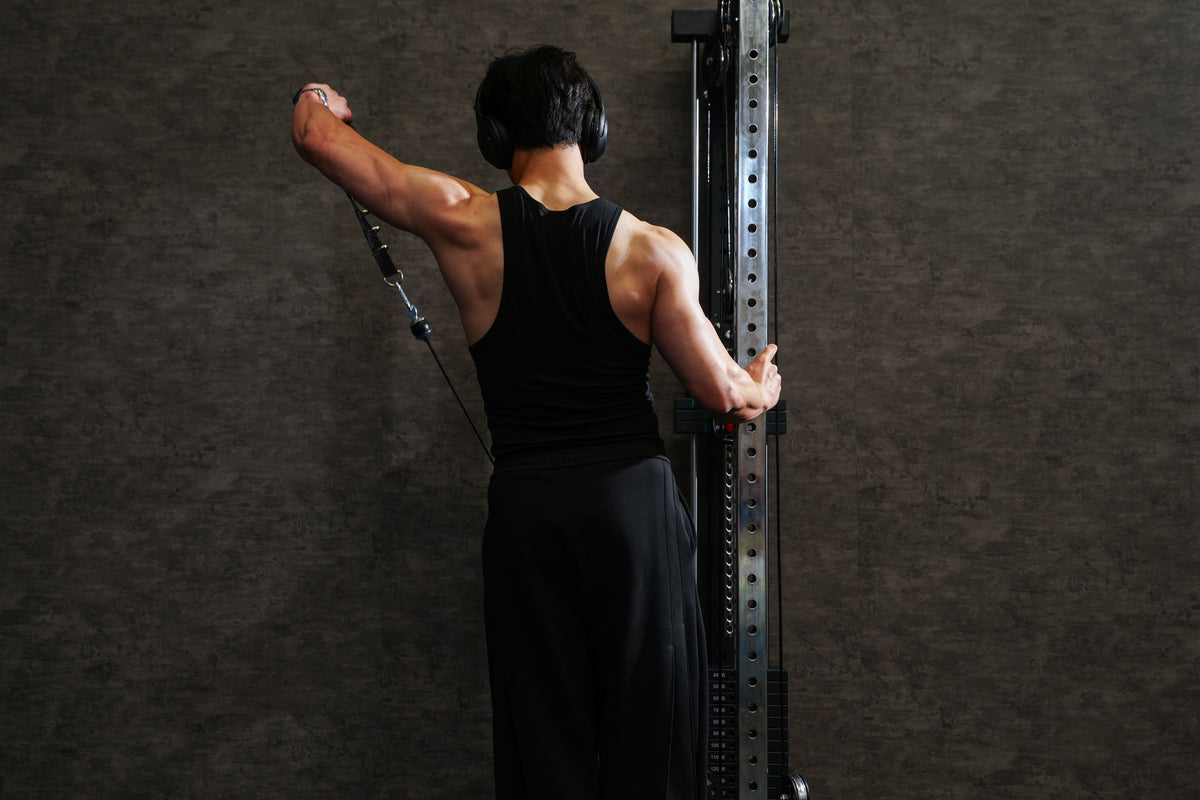 Person using a cable machine in a gym setting