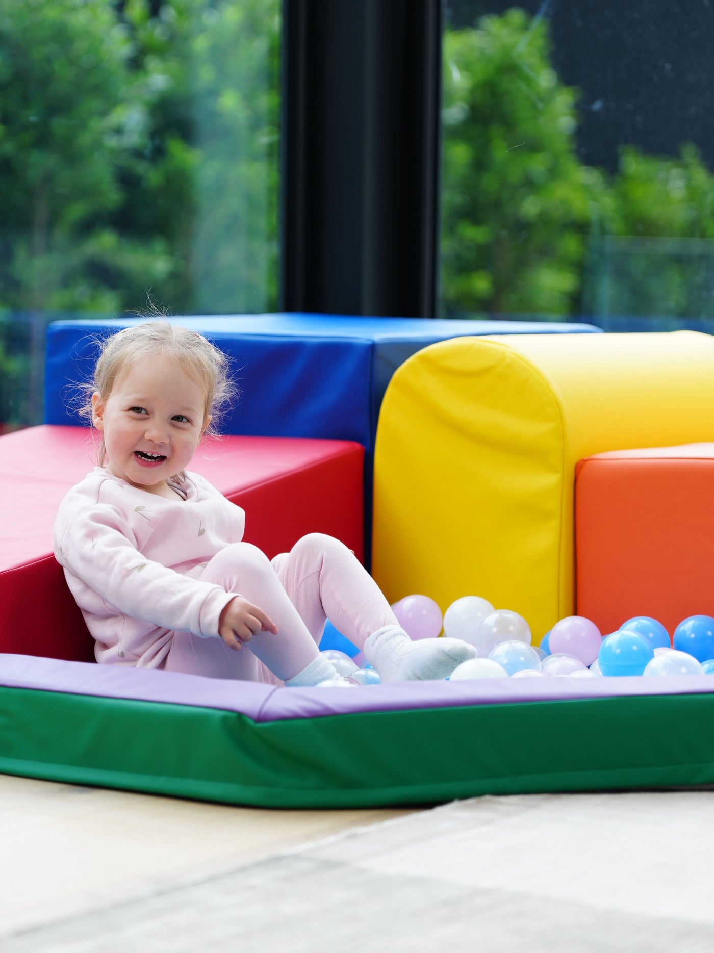 A toddler playing in the ball-pit of the MEMAX Sensory Soft Play Building Blocks