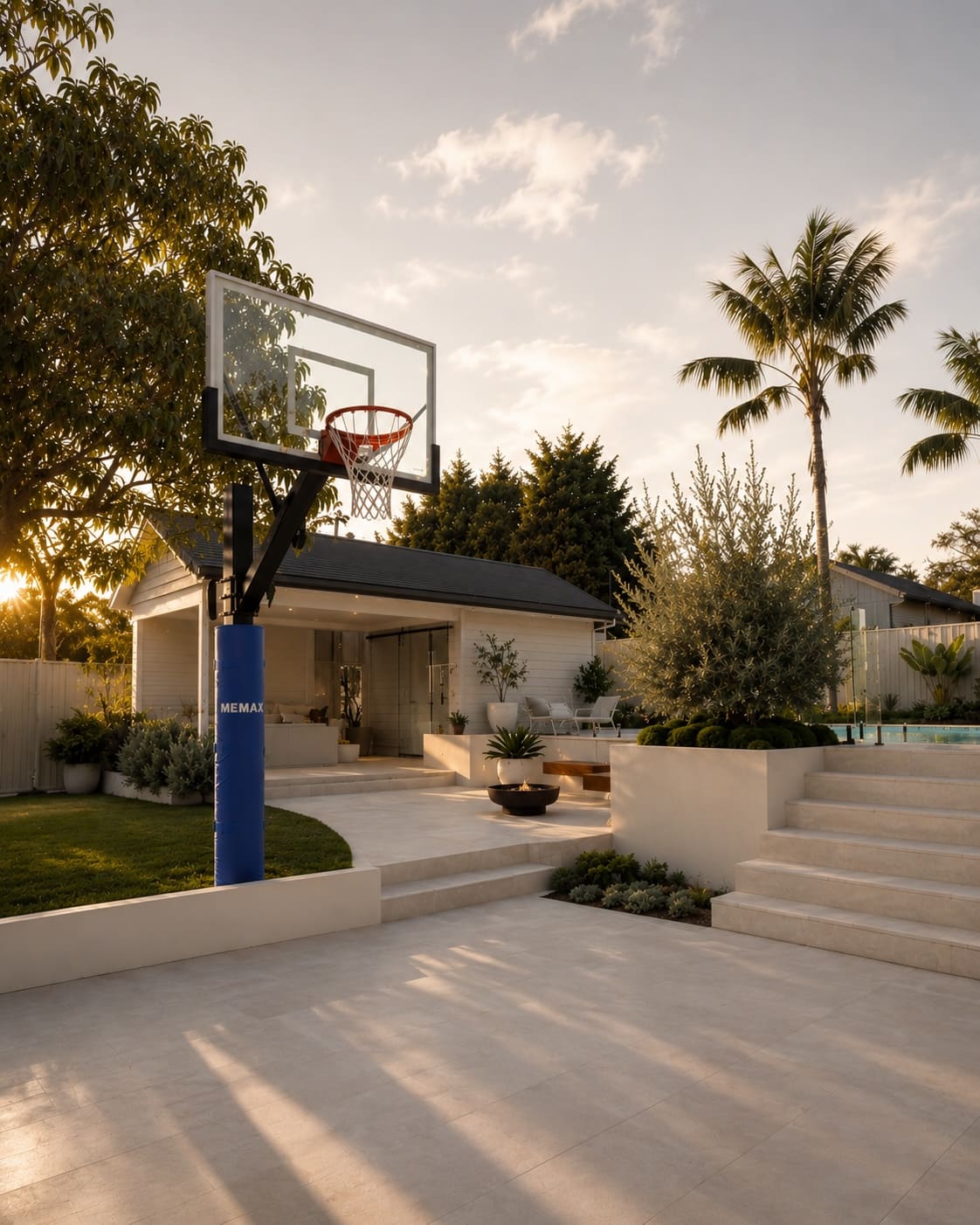 Outdoor basketball hoop in a backyard setting with trees and a pool in the background, with MEMAX post padding.