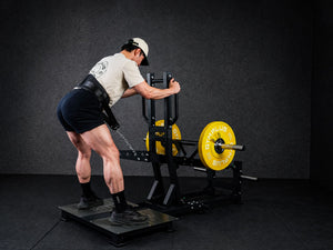 Gym Plus Belt Squat Machine - Plate Loaded BELT-SQUAT-01 a man performing belt squat while holding multi-angle handle