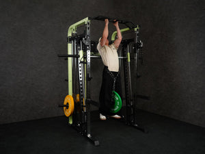 Gym Plus Power Dip Belt POWERBELT a man performing pull up using the dip belt with green bumper plates
