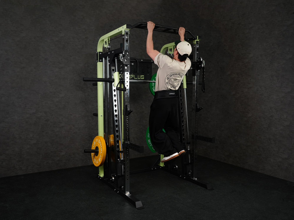 Gym Plus Power Dip Belt POWERBELT a man performing pull up using the dip belt with green bumper plates, back view