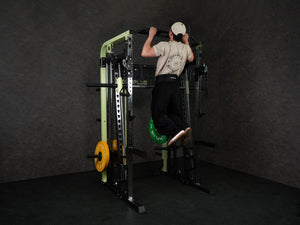Gym Plus Power Dip Belt POWERBELT a man performing pull up using the dip belt with green bumper plates, back view