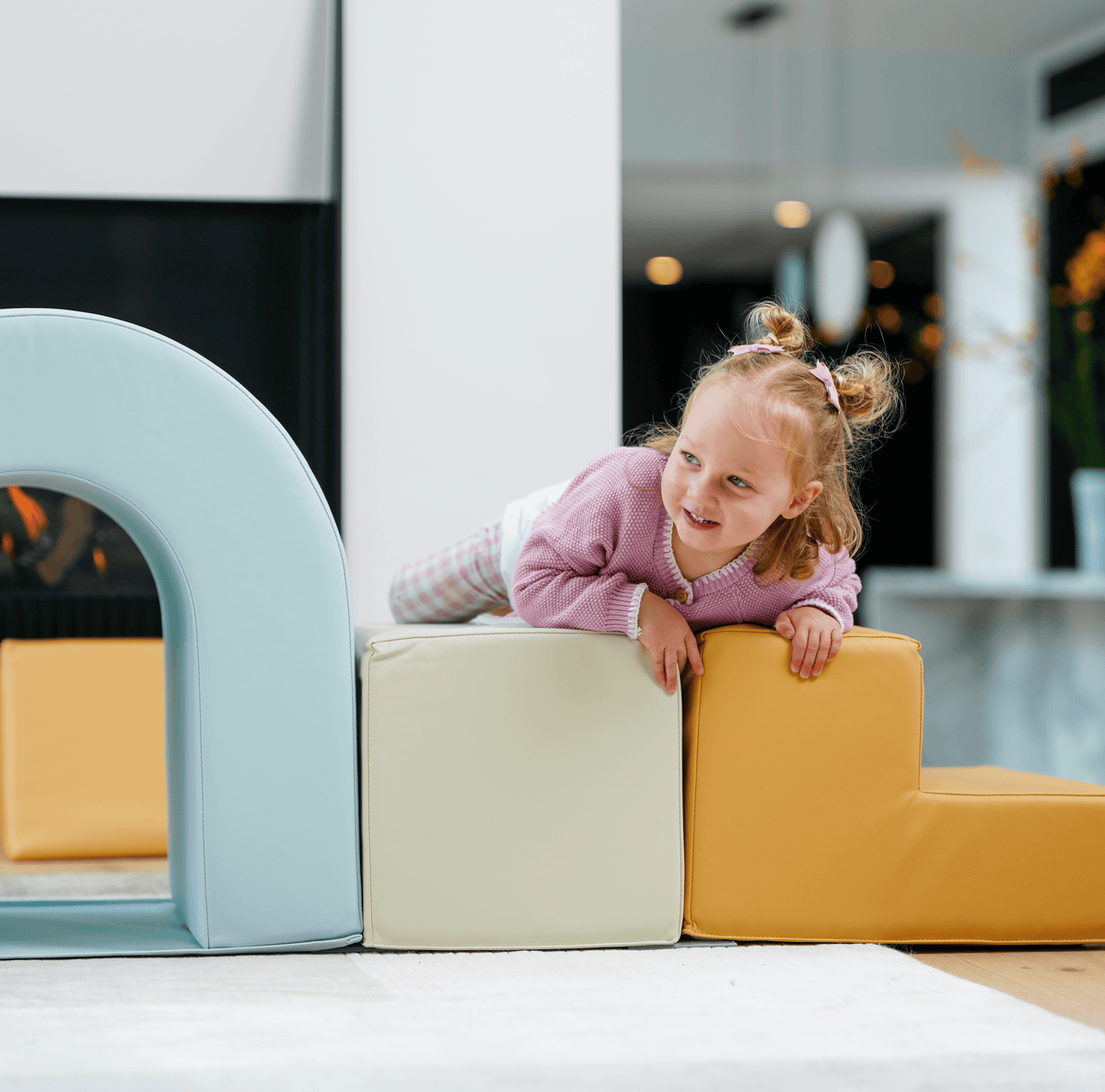 A toddler climbing on the Sensory Soft Play Building Blocks 