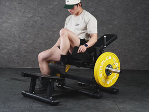 Gym Plus Hip Thrust Machine - Plate Loaded BELT-HT-01 a man performing hip thrust with yellow bumper plates